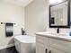 Beautiful renovated bathroom with a soaking tub, sleek black fixtures, and a marble countertop vanity at 133 Orange Ridge Dr, Longwood, FL 32779
