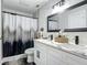 Stylish bathroom with double sinks, granite countertop, framed mirror, and elegant shower at 133 Orange Ridge Dr, Longwood, FL 32779