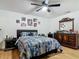 Cozy bedroom featuring a comforter, nightstand and dresser with decorative pictures at 133 Orange Ridge Dr, Longwood, FL 32779