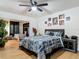 Bedroom with hardwood floors, natural lighting, floral comforter, and decorative pictures at 133 Orange Ridge Dr, Longwood, FL 32779