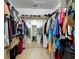 Spacious walk-in closet with racks and shelves for optimal storage and mirror in adjacent space at 133 Orange Ridge Dr, Longwood, FL 32779