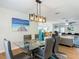 Open-concept dining room showcases a glass table, modern lighting, and seamless flow into living spaces at 133 Orange Ridge Dr, Longwood, FL 32779