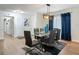 Bright dining room features modern lighting, glass table, and seating for six with blue accents at 133 Orange Ridge Dr, Longwood, FL 32779
