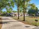 A well-maintained home with mature trees, a long driveway, and a screened-in pool area at 133 Orange Ridge Dr, Longwood, FL 32779