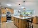 Well-lit kitchen features an island with seating, stainless steel appliances, and lots of cabinets at 133 Orange Ridge Dr, Longwood, FL 32779