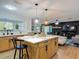 Bright kitchen with a center island, stainless steel appliances, and a view into the Gathering room at 133 Orange Ridge Dr, Longwood, FL 32779