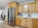 Bright kitchen view features stainless steel refrigerator and lots of cabinets at 133 Orange Ridge Dr, Longwood, FL 32779