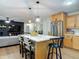 Kitchen featuring an island with barstool seating that overlooks a living area at 133 Orange Ridge Dr, Longwood, FL 32779