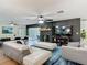 Spacious living room with fireplace, open to dining area with natural light and stylish furnishings at 133 Orange Ridge Dr, Longwood, FL 32779