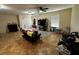 Open living room provides ceiling fan, neutral walls, tile floors, checkered rug, and natural light at 133 Orange Ridge Dr, Longwood, FL 32779