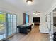 Spacious living area with wood floors, sliding glass doors, and comfortable seating arrangement at 133 Orange Ridge Dr, Longwood, FL 32779