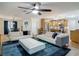 Bright living room featuring stylish white sofas, a blue rug, and an open layout with a view into the kitchen at 133 Orange Ridge Dr, Longwood, FL 32779
