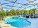 Sparkling screened in pool features blue tile trim, patio furniture and views of the property at 133 Orange Ridge Dr, Longwood, FL 32779