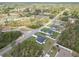 An aerial view shows a community with well-maintained lawns and beautiful homes nestled among lush greenery at 16121 Sw 37Th Terrace Rd, Ocala, FL 34473