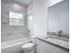 Modern bathroom with tiled walls, granite vanity, and a tub with shower combo at 16121 Sw 37Th Terrace Rd, Ocala, FL 34473