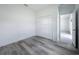 Bright bedroom with wood-look floors, closet, and door leading to the next room at 16121 Sw 37Th Terrace Rd, Ocala, FL 34473