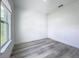 Bedroom with light wood-look flooring and a large window at 16121 Sw 37Th Terrace Rd, Ocala, FL 34473