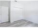 Bedroom featuring wood-look floors, closet, and a white door to the hallway at 16121 Sw 37Th Terrace Rd, Ocala, FL 34473