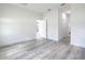 Minimalist bedroom with wood floors and open hallway with a door at 16121 Sw 37Th Terrace Rd, Ocala, FL 34473
