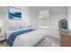 Beautiful bedroom featuring a queen bed, patterned rug, and a window with outside views at 16121 Sw 37Th Terrace Rd, Ocala, FL 34473