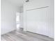 Bedroom featuring wood-look floors, large closet, and a white door to the hallway at 16121 Sw 37Th Terrace Rd, Ocala, FL 34473