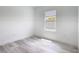Bright bedroom with wood-look floors and a window with views of the outside at 16121 Sw 37Th Terrace Rd, Ocala, FL 34473
