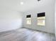Bright bedroom with wood floors and natural light from two windows with black blinds at 16121 Sw 37Th Terrace Rd, Ocala, FL 34473