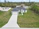 New construction featuring a well-manicured lawn and concrete driveway leading to an attached two-car garage at 16121 Sw 37Th Terrace Rd, Ocala, FL 34473