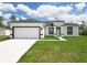 Close-up view of a new construction with a white exterior, a black roof and black trim around the door and windows at 16121 Sw 37Th Terrace Rd, Ocala, FL 34473