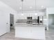 Updated kitchen featuring white cabinetry, stainless steel appliances, a granite countertop, and laundry area at 16121 Sw 37Th Terrace Rd, Ocala, FL 34473