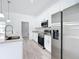 Modern kitchen features stainless steel appliances, white cabinets, granite countertops, and wood floors at 16121 Sw 37Th Terrace Rd, Ocala, FL 34473