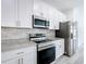 Well-equipped kitchen with white cabinets, stainless steel appliances, and granite countertops at 16121 Sw 37Th Terrace Rd, Ocala, FL 34473