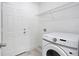 Bright laundry room featuring a white Samsung washing machine and wire shelving for storage at 16121 Sw 37Th Terrace Rd, Ocala, FL 34473