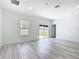Bright living room with wood floors, a window, and sliding glass doors to the backyard at 16121 Sw 37Th Terrace Rd, Ocala, FL 34473