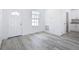 Bright, open living space featuring wood-look flooring, white walls, and natural light from a window at 16121 Sw 37Th Terrace Rd, Ocala, FL 34473