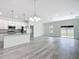 Bright, open living space with white walls, a view of the modern kitchen, and sliding glass doors at 16121 Sw 37Th Terrace Rd, Ocala, FL 34473