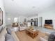 Spacious living room featuring a sofa, chairs, coffee table, and view into the dining and kitchen areas at 16121 Sw 37Th Terrace Rd, Ocala, FL 34473