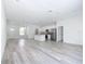 Expansive living area with wood-look flooring and an open layout flowing into the kitchen and dining spaces at 16121 Sw 37Th Terrace Rd, Ocala, FL 34473