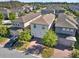 Aerial view of a neighborhood showcasing well-manicured lawns, mature trees, and a black SUV in the driveway at 17055 Wynford Ln, Winter Garden, FL 34787