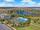 Aerial view of community pool surrounded by trees and greenery and residential homes at 17055 Wynford Ln, Winter Garden, FL 34787