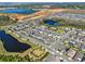 Beautiful aerial view of a Primary planned community featuring multiple lakes and a community park at 17055 Wynford Ln, Winter Garden, FL 34787