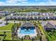 Stunning aerial view of a neighborhood pool with lounge chairs and manicured landscaping at 17055 Wynford Ln, Winter Garden, FL 34787