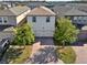 Aerial shot of a two-story home with a brick driveway and mature trees at 17055 Wynford Ln, Winter Garden, FL 34787