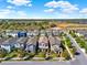 Aerial view of a neighborhood with manicured lawns, mature trees, and a nearby lake at 17055 Wynford Ln, Winter Garden, FL 34787