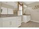 Bathroom with double sink vanity, granite countertops and white cabinets at 17055 Wynford Ln, Winter Garden, FL 34787