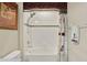 Bright bathroom features a shower/tub combo with white tile surround and decorative shower curtain at 17055 Wynford Ln, Winter Garden, FL 34787