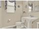 Elegant powder room features a pedestal sink and decorative accents at 17055 Wynford Ln, Winter Garden, FL 34787