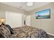 Comfortable bedroom features a large closet, and mounted TV at 17055 Wynford Ln, Winter Garden, FL 34787