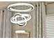 Close up of a modern crystal chandelier creating a luxurious ambiance in this house at 17055 Wynford Ln, Winter Garden, FL 34787