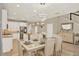 Elegant dining area with a stylish table set, modern lighting, and seamless transition to the kitchen and living spaces at 17055 Wynford Ln, Winter Garden, FL 34787